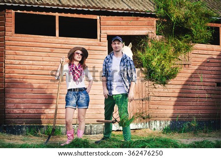 man and woman on the stables with hay