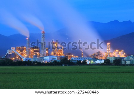 View of a factory in the middle of a green Farmland in the early morning ~