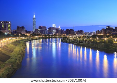 Night view of Taipei city with the bridge and beautiful reflection by riverside  ~ Landmark of Taipei, Taipei 101,  Keelung river, Xinyi district and downtown area at dusk