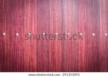 Closeup of the wood door with metal stud background