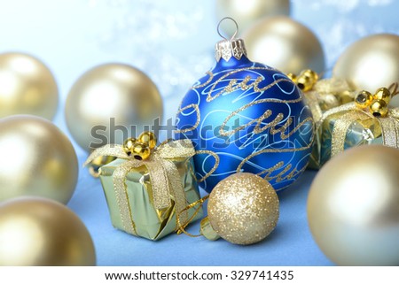 Christmas balls blue and gold with gift box present on blue background new year
