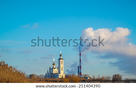 little church on the Hill against the sky and smoke pipes