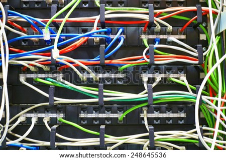 Technician is cutting wires using pliers of server in data center