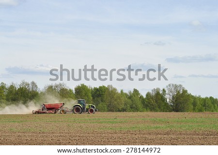Moscow region, Russia - May 14: Planting tractor trailed planter in the field near Moscow May 14, 2015