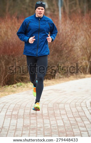 Man running in park in cold weather