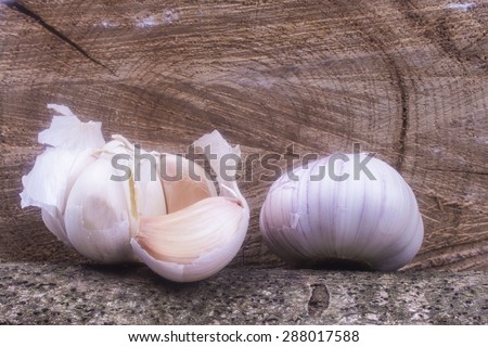 one large garlic with garlic disclosed on the balance beam