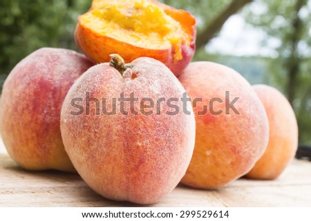 Bitten juicy peach on a pile of peaches