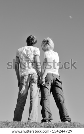 Young happy couple looking to horizon. Black and white photography