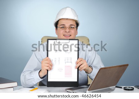 An engineer with white hard hat holding clipboard on gray background