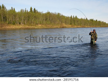 Fly fishing on river in wildness