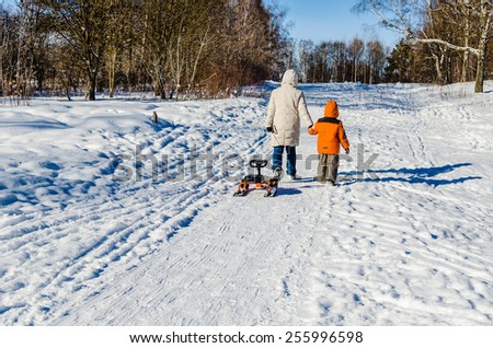 Mother and the child walk in the winter wood, Russia/ Walk together