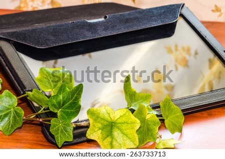 Image of an e-book, tablet, notebook on the table with reflection effect/ Communication tools