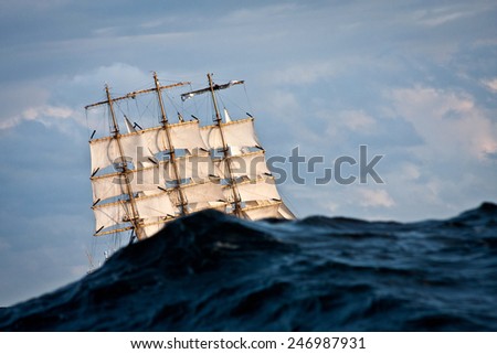 Sailing boat covered by the wave