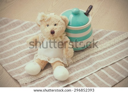 Green pastel porcelain jar and little bear doll in vintage style.