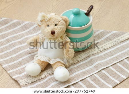 Green pastel porcelain jar and little bear doll with cute fabric.