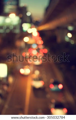 Vintage style of night traffic light blurred. The city lights background