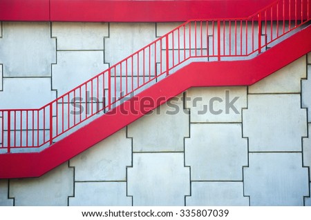 Red stairs and concrete wall