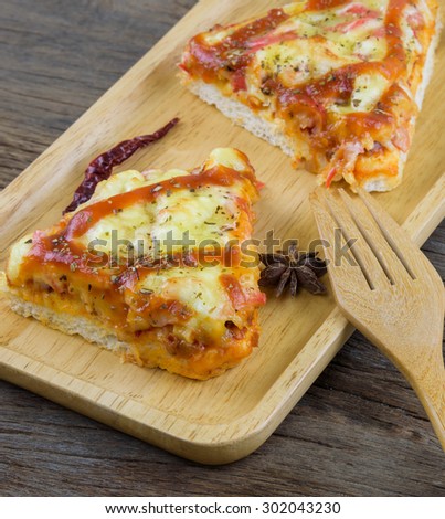 Crab Pizza cheese is placed on a wooden tray.