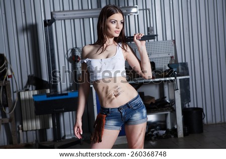 Young and sexy woman in garage