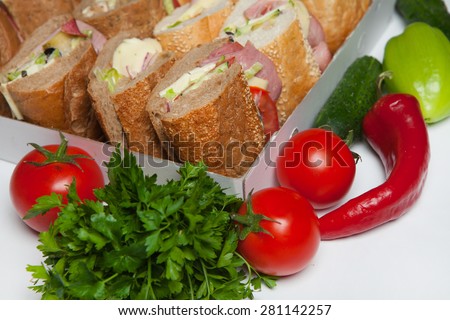 Sandwich with bacon and vegetables. Assorted delicious baguette sandwiches.