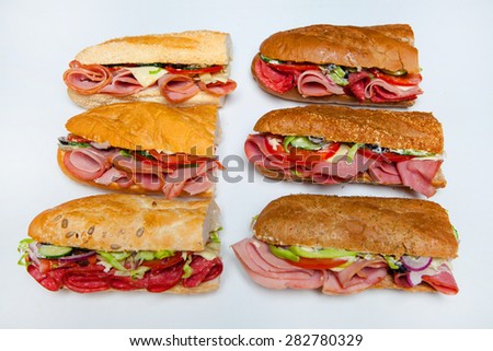 Fresh sandwich isolated on white. Assorted delicious baguette sandwiches.