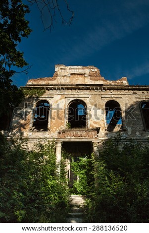 Facade of old destroyed house with broken windows. Old Abandoned House