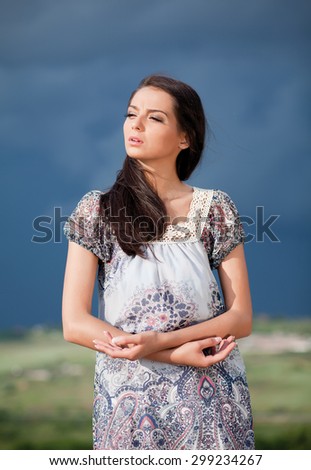 Portrait of young attractive woman.Beautiful sad girl outside.Portrait of beautiful girl in the nature on colorful spring day.