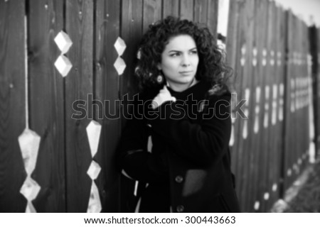Blurred portrait of depressed young woman.Portrait of young attractive woman in the darkness.Sad woman in black and white.