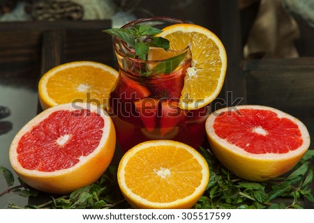 Fruit cocktail with fruits.Fruit Ice Tea. Iced juice.Cocktail with ice and lemon
