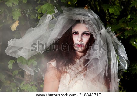 Halloween face art. Portrait of beautiful zombie corpse bride looked scary in forest. Halloween.bride.