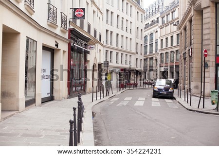 PARIS, FRANCE - APRIL 09, 2013: Paris streets. City of Love IN France. Street of Paris. Spring in Paris.Paris architecture: Old narrow street of Paris, Europe