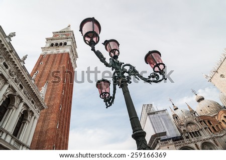 Beautiful ornate lampposts in Piazza San Marco against campanile San Marco in Venice, Italy.