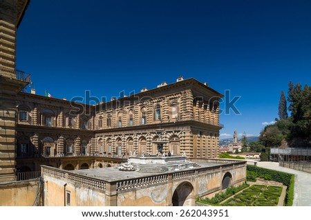 FLORENCE, ITALY - APRIL 14, 2013: Facade of Pitti Palace with fountain and Boboli Gardens, Unesco World Heritage site. Florence, Tuscany, Italy.
