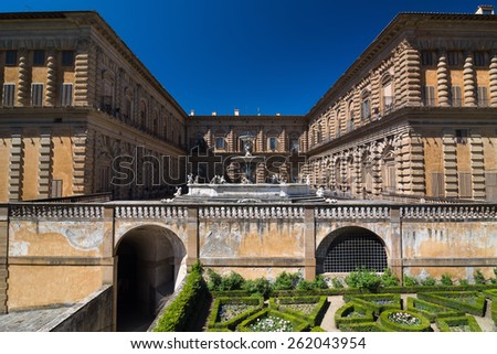 FLORENCE, ITALY - APRIL 14, 2013: Facade of Pitti Palace with fountain and Boboli Gardens, Unesco World Heritage site. Florence, Tuscany, Italy.
