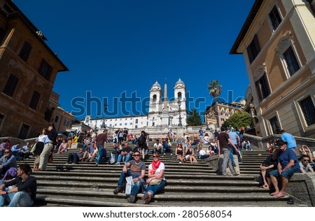 ROME - APRIL 17, 2013: Spanish Steps in Rome, Italy. Tourists relax in the famous Spanish steps between the Piazza di Spagna and roman catholic titular church of the Santissima Trinita dei Monti.