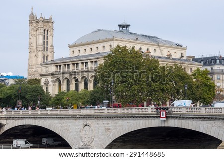 PARIS - SEPT 17, 2014: The Pont au Change is a bridge over the Seine River in Paris, France. City Theatre and Saint-Jacques Tower on background.