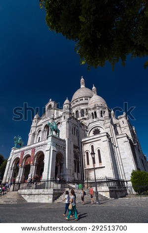 PARIS - SEPT 16, 2014: Tourists near the Basilica of the Sacred Heart of Paris (Sacre-Coeur) is a Roman Catholic church. Located at the summit of the butte Montmartre. Paris, France.
