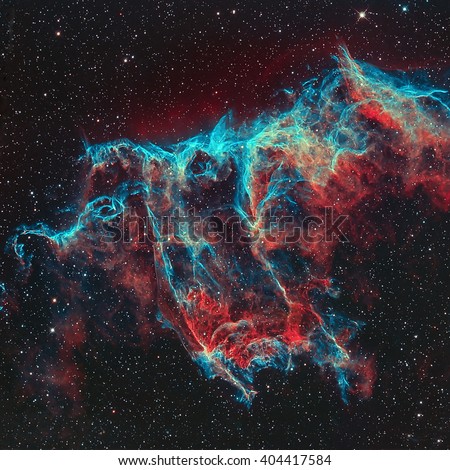 The Veil Nebula (The Witch\'s Broom Nebula) is a cloud of heated and ionized gas and dust in the constellation Cygnus. Retouched colored image. Elements of this image furnished by NASA.