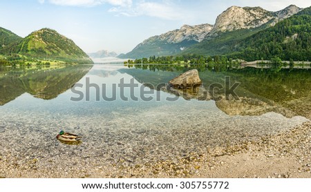 Austrian Lake in the Morning. The great quiet and pleasant atmosphere before nature and people wake up to the brand new day. Even the duck in foreground is still sleeping :-)