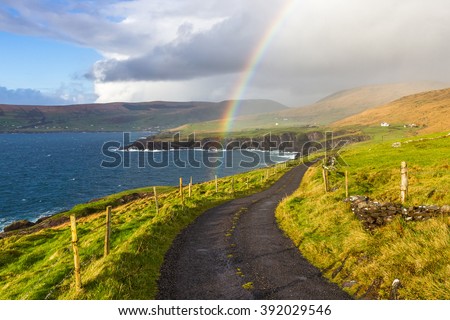 Typical Ireland - Coast, green grass, blue skies, clouds, rain coming, rainbow. Beautiful, amazing, breathtaking.