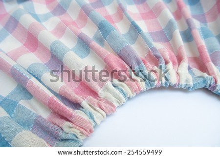 Part of pucker fabric background. Pastel color scot pattern on fabric.