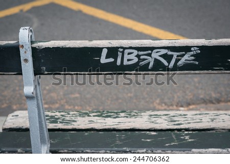 Word Freedom written on a bench in Paris