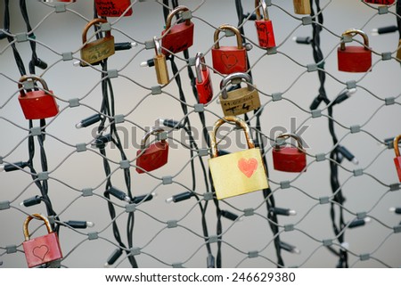 Many red locks and one gold lock with a drawn heart