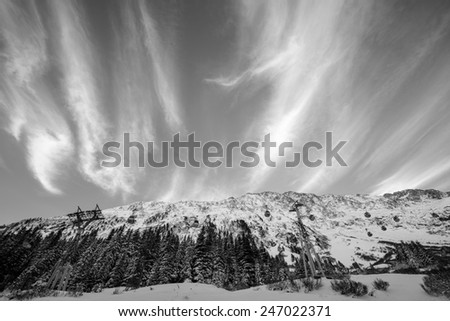 Black and white image of a mountain and the austrian sky