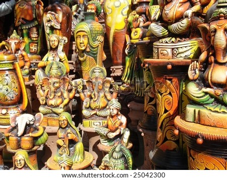 indian gods and goddesses in orange-yellow pottery work