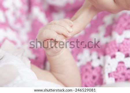 Baby hand in dad or mom hand