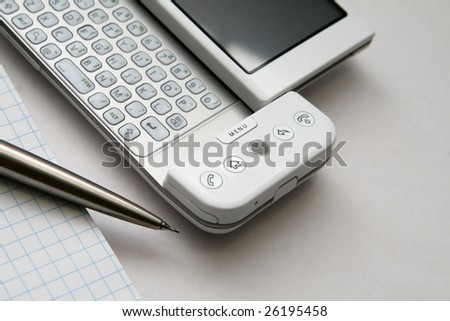 Checked blue pad, silver pen and brand new mobile phone isolated on white background