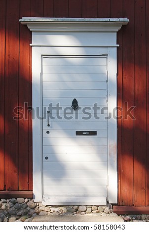 White wooden doors to the scandinavian house with stony doorstep at Porvoo city