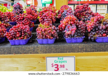 Group baskets of fresh organically grown red grapes in the farmer market at Puyallup, Washington, USA.