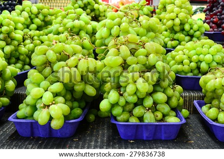 Group baskets of fresh organically grown pristine green grapes in the farmer market at Puyallup, Washington, USA.